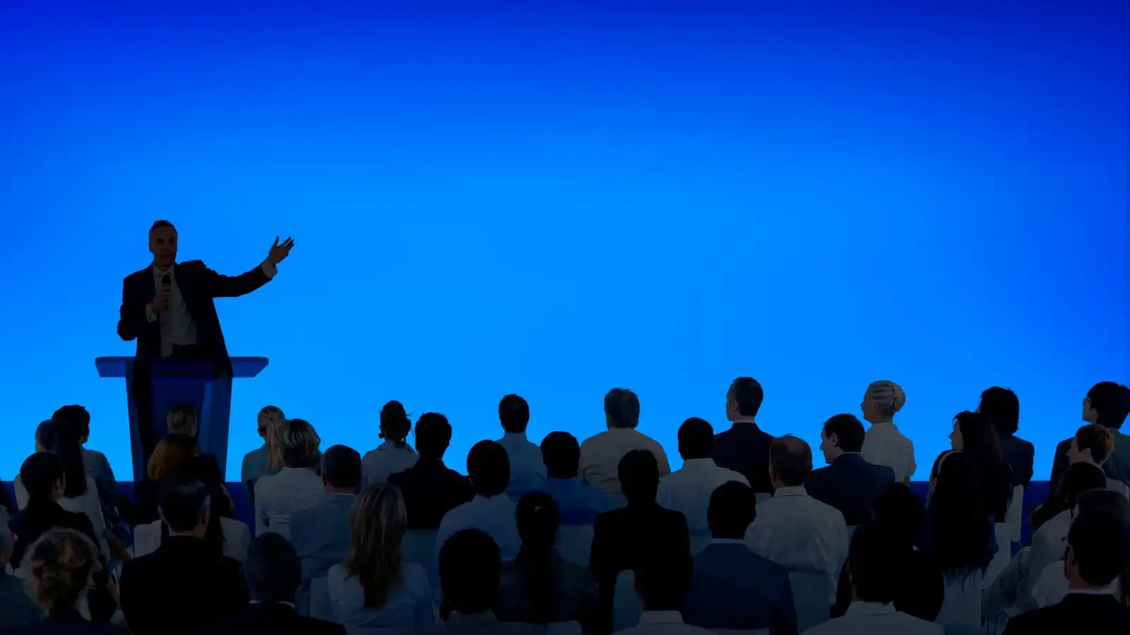 Speaker presenting to a conference audience