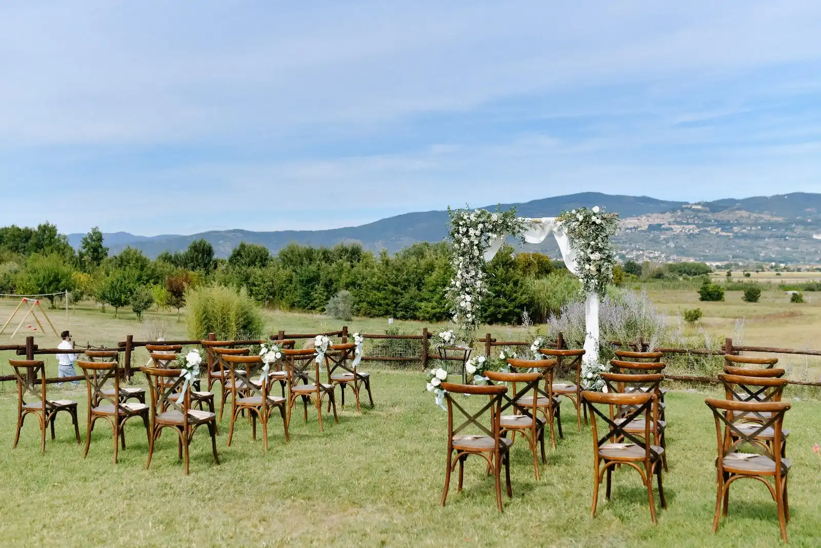 Wedding ceremony set-up with arch and chairs